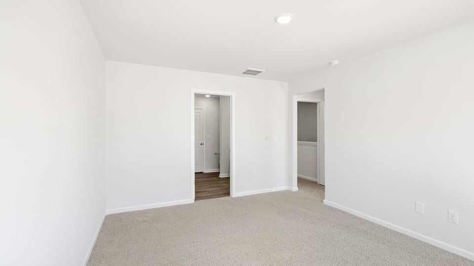 Bedroom with carpet and window.
