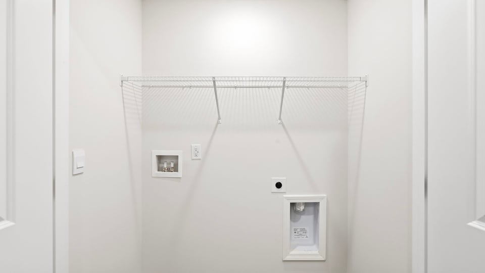 Laundry room with hanging storage racks.