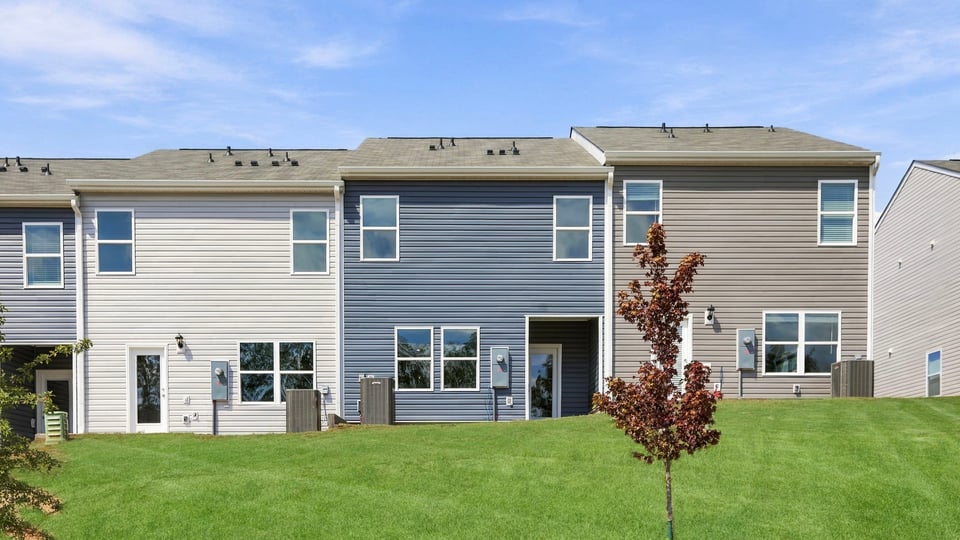 Back exterior of home with large backyard.