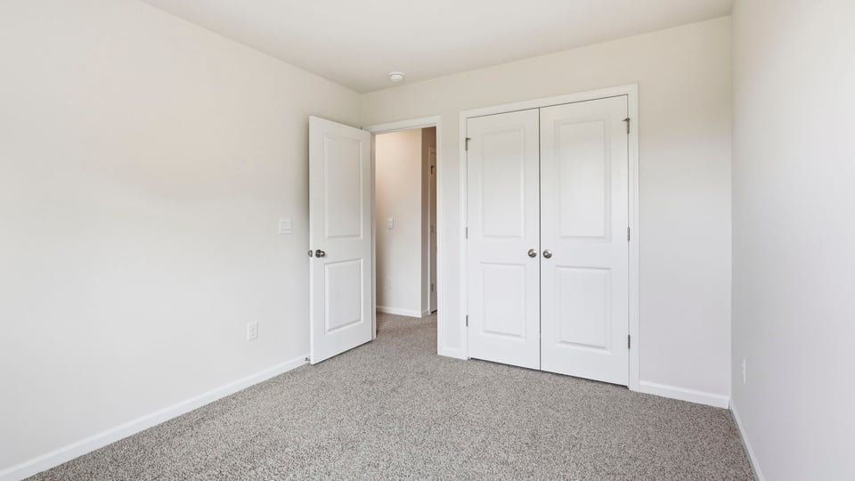 Bedroom with carpet and window.