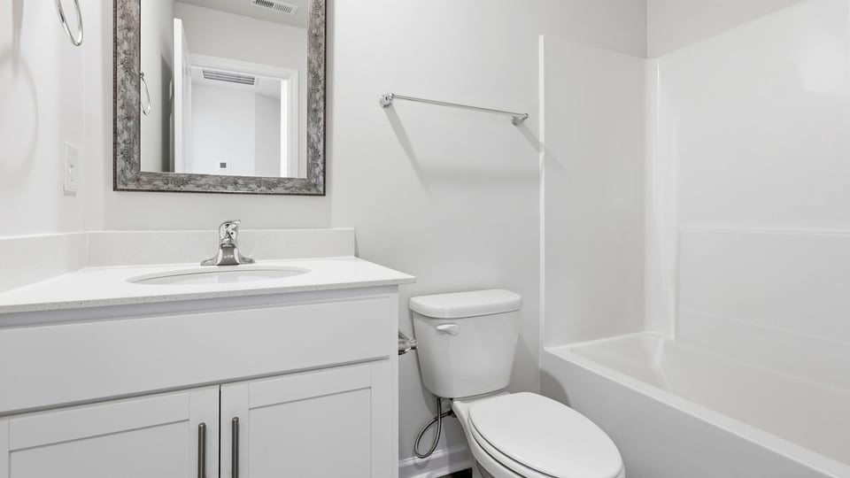 Bathroom with single vanity sink and bathtub.