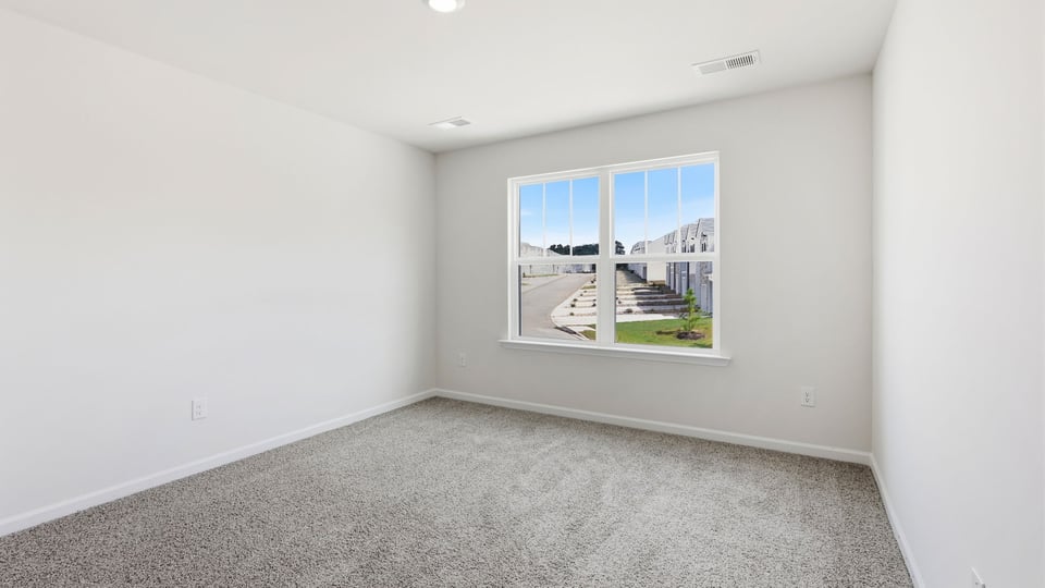 Bedroom with carpet and window.