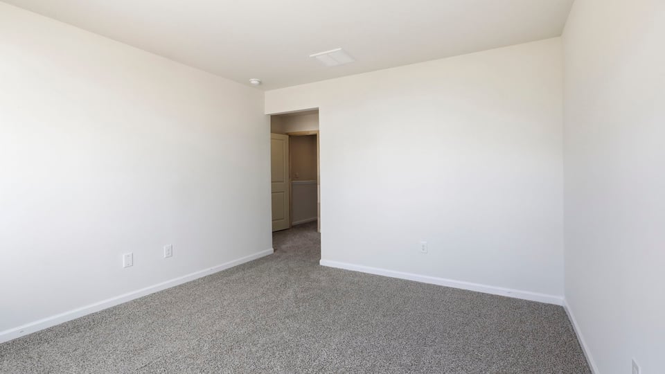 Bedroom with carpet and window.