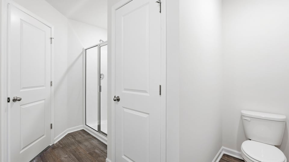 Bathroom with walk in shower and closet.