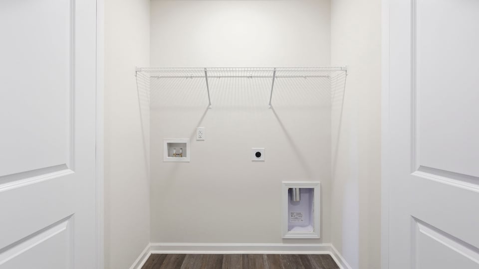 Laundry room with hanging storage racks.