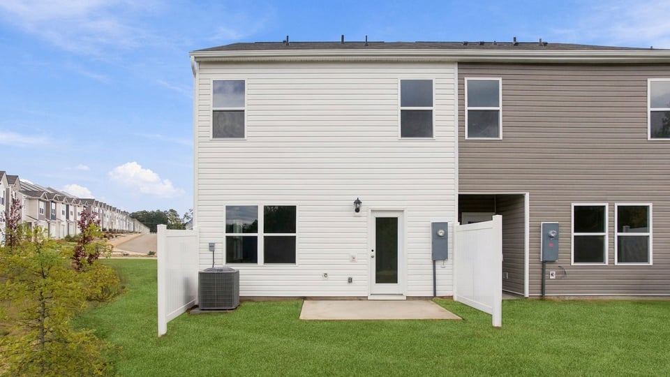 Back exterior of home with large backyard.