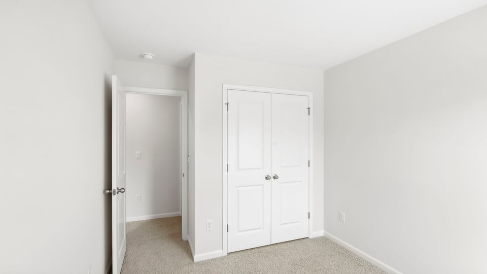Bedroom with carpet and window.