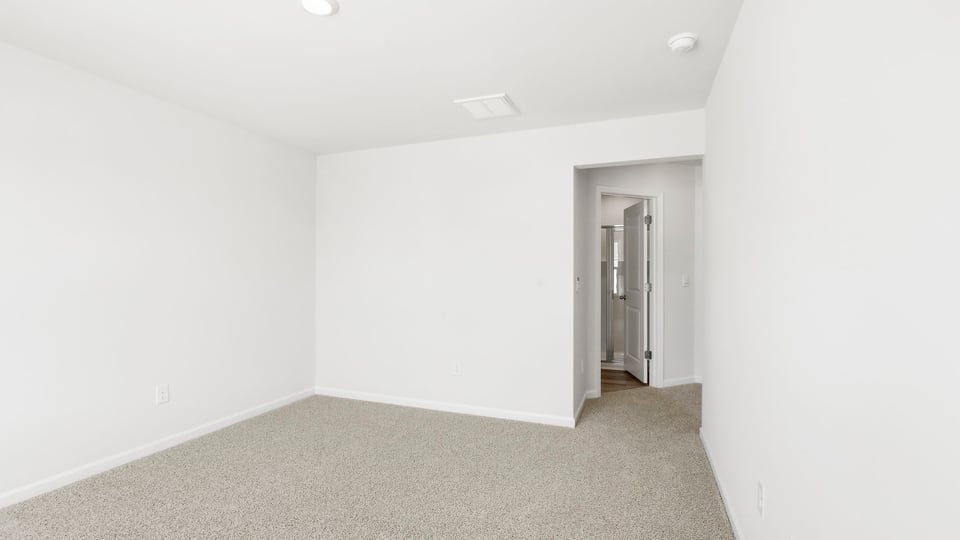 Bedroom with carpet and window.
