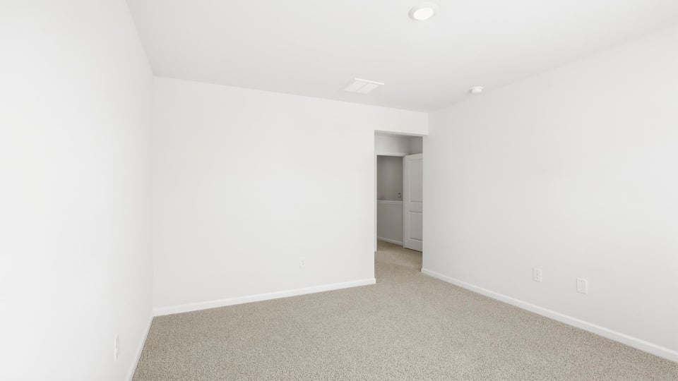 Bedroom with carpet and window.