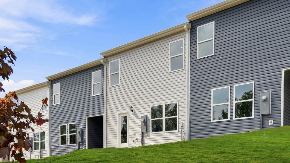 Back exterior of home with large backyard.
