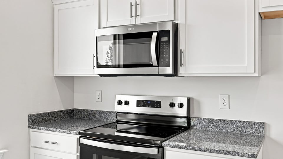 Kitchen and island with stainless steel appliances.