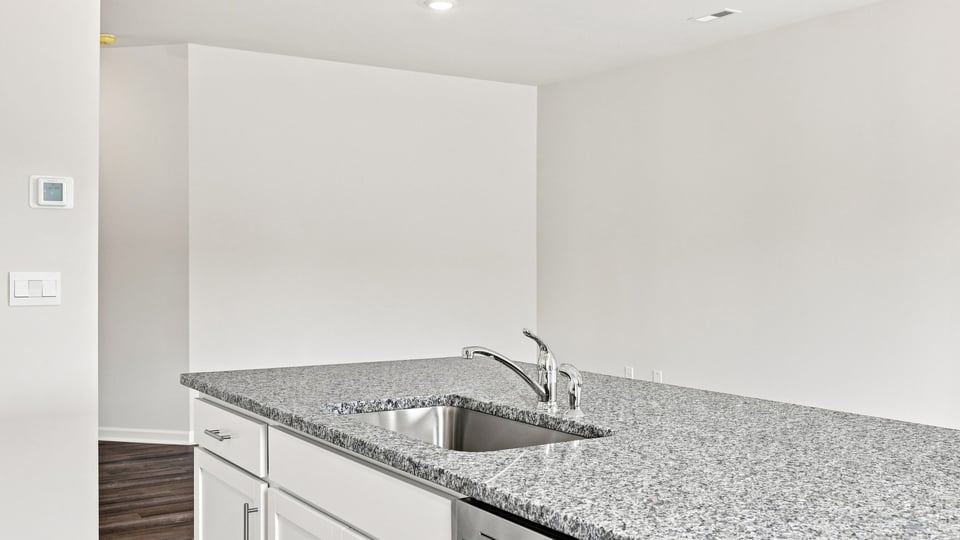 Kitchen and island with stainless steel appliances.
