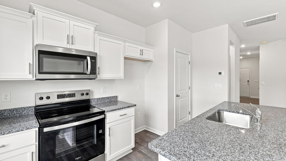 Kitchen and island with stainless steel appliances.