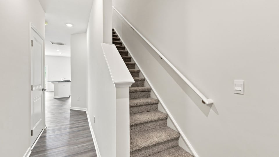 View of stairs with carpet,