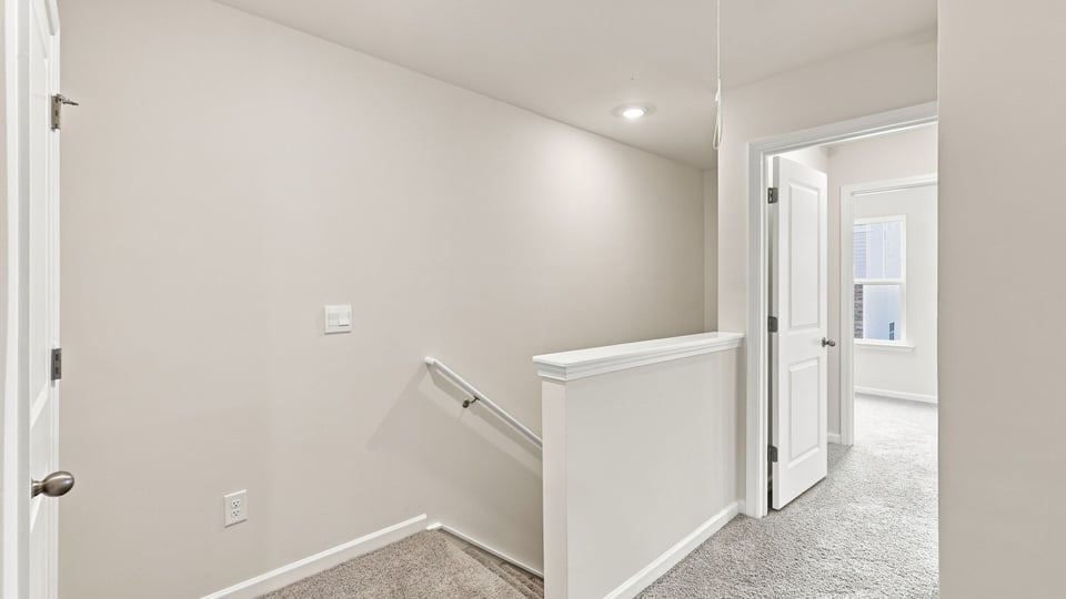Loft area with carpet.