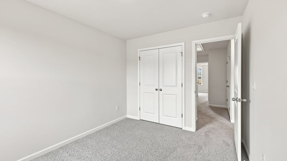 Bedroom with carpet and window.