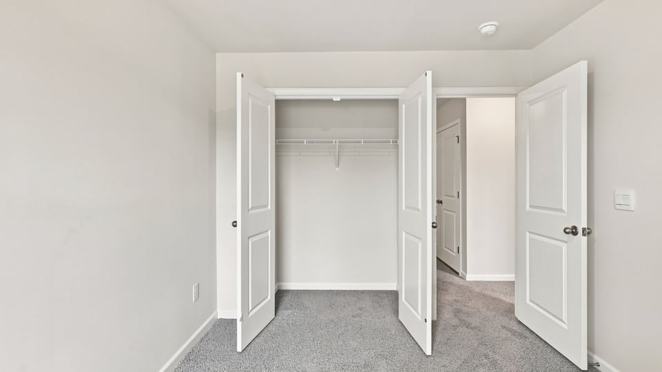 Bedroom with carpet and window.
