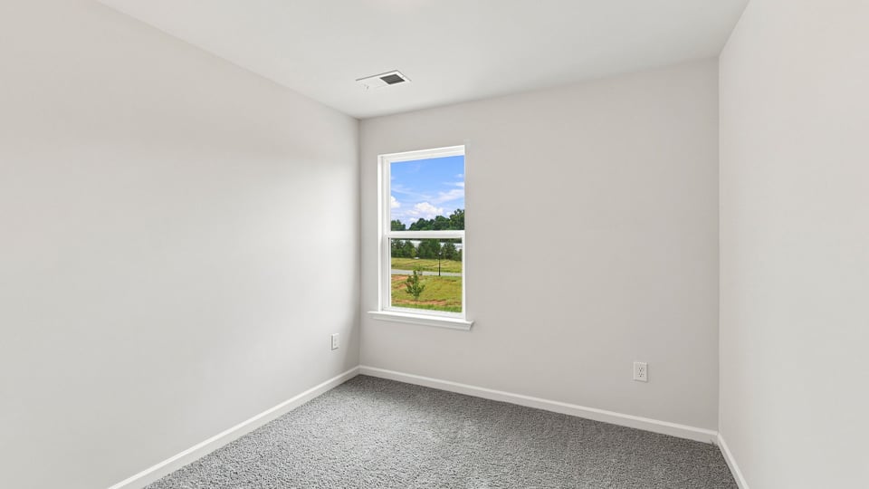 Bedroom with carpet and window.