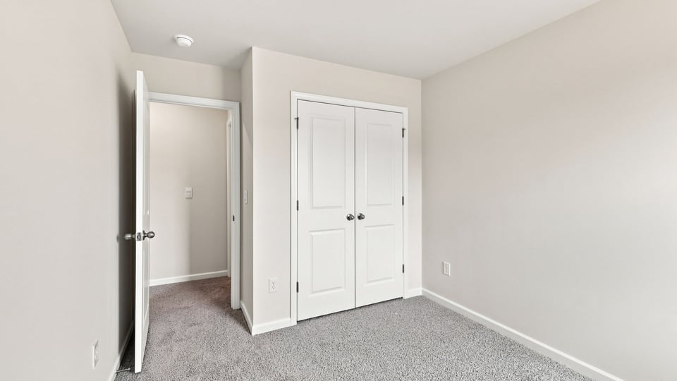 Bedroom with carpet and window.