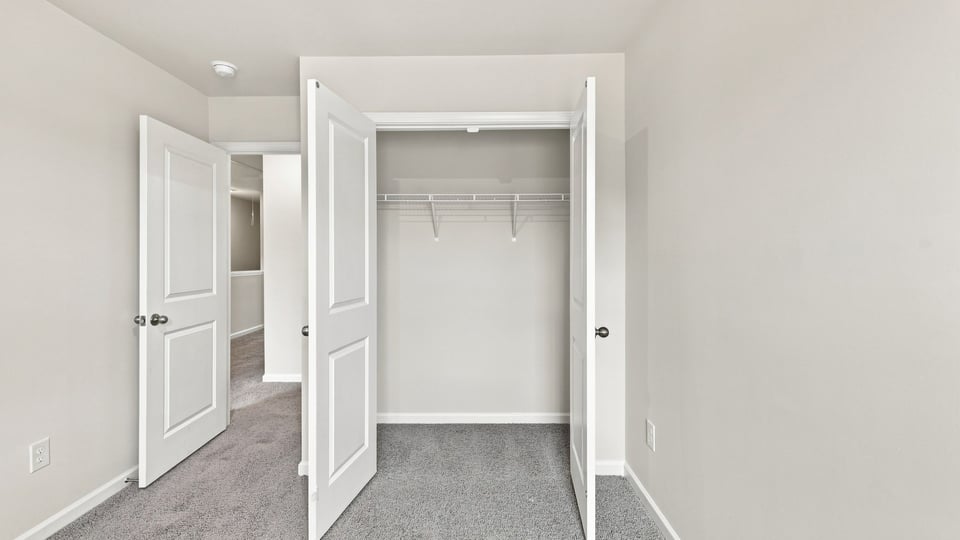 Bedroom with carpet and window.