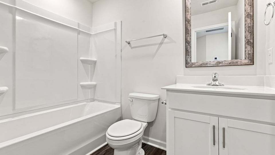 Bathroom with single vanity sink and bathtub.