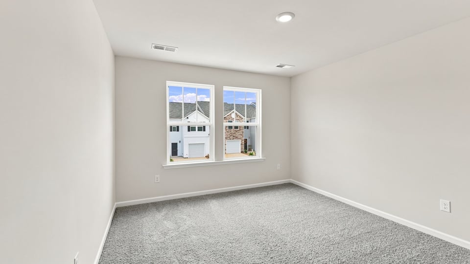 Bedroom with carpet and window.