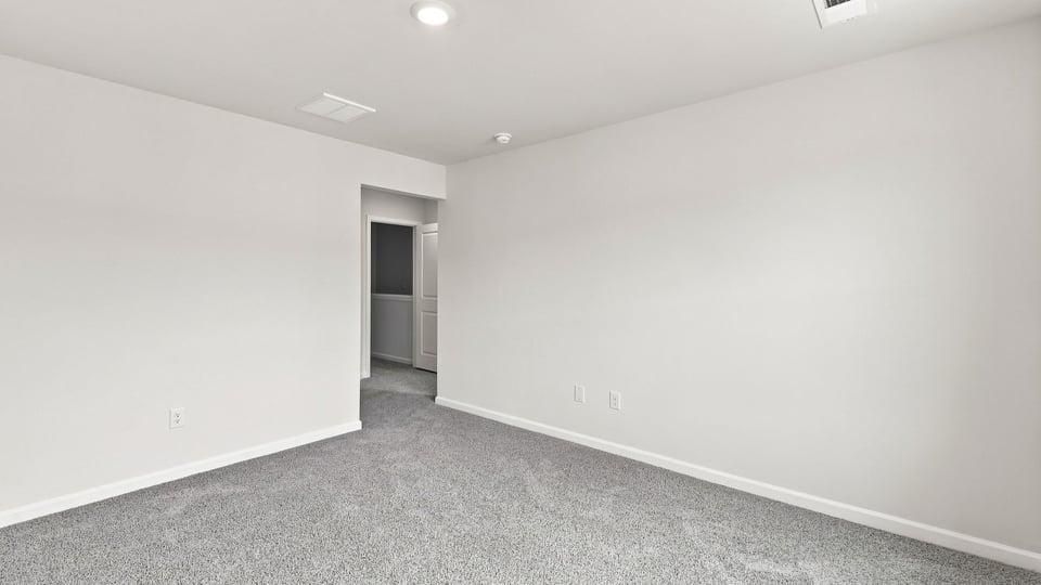 Bedroom with carpet and window.