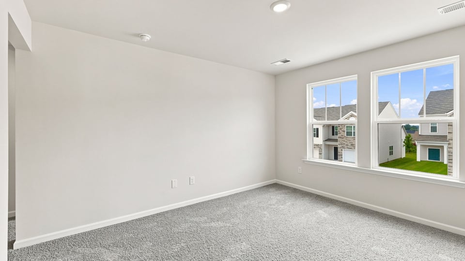 Bedroom with carpet and window.