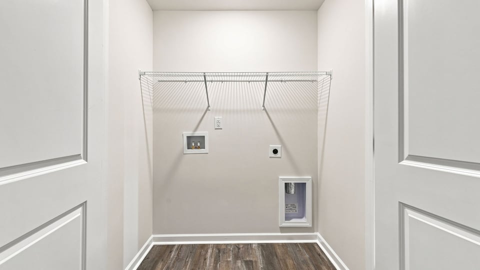 Laundry room with hanging storage racks.
