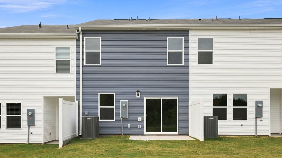 Back exterior of home with large backyard.