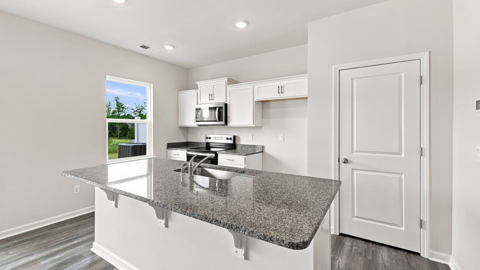 Kitchen with island and cabinets.