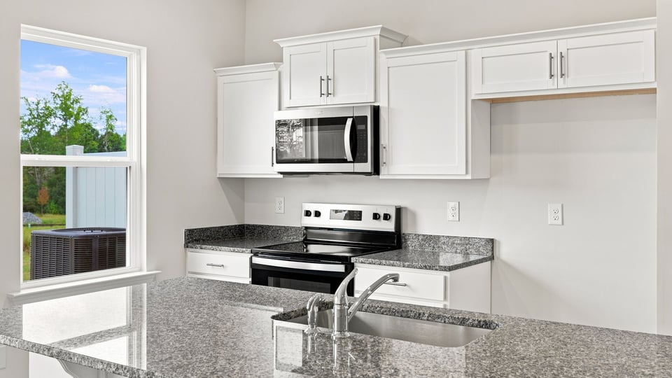 Kitchen with island and cabinets.