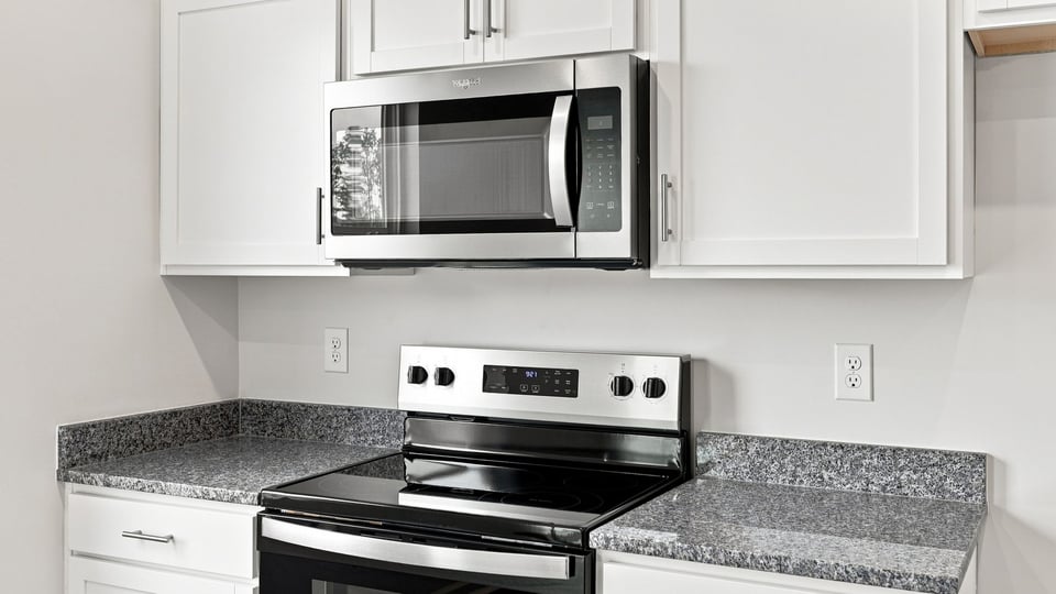 Kitchen with island and cabinets.