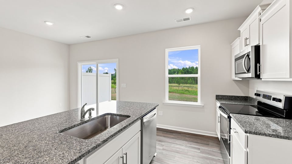 Kitchen with island and cabinets.
