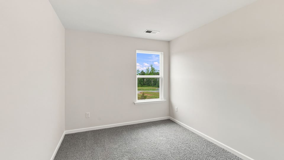 Bedroom with carpet and windows.