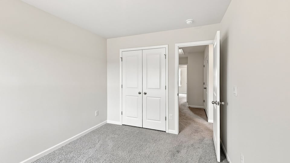 Bedroom with carpet and windows.