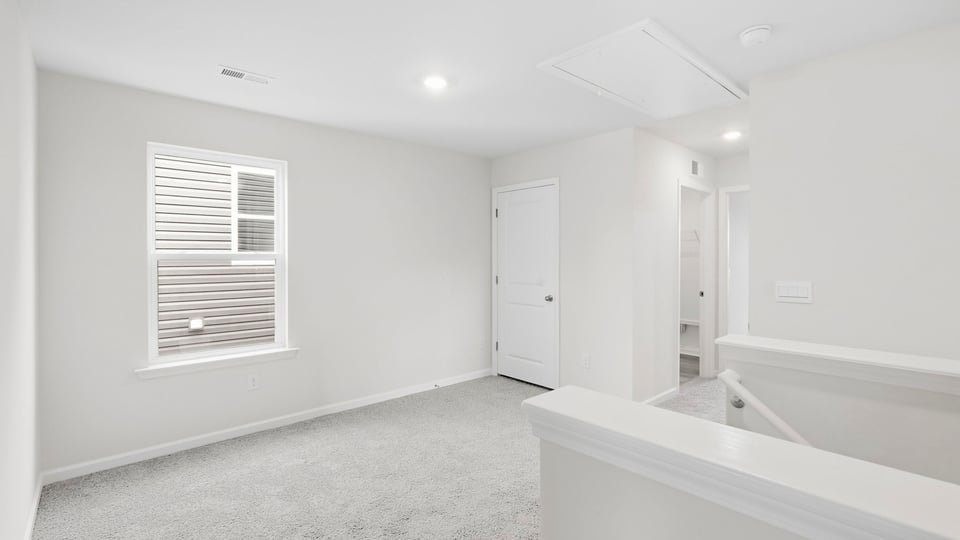 Bedroom with carpet and window.