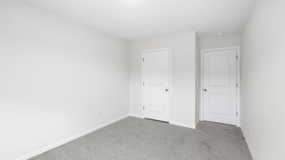 Bedroom with carpet and window.