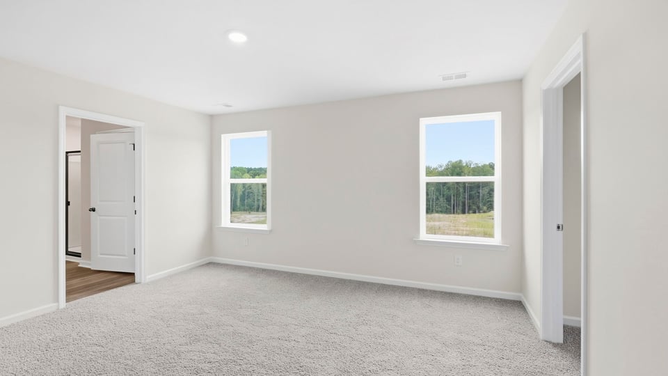 Bedroom with carpet and window.