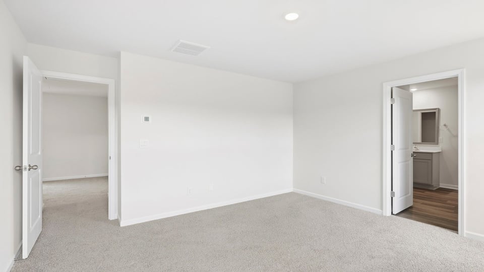 Bedroom with carpet and window.