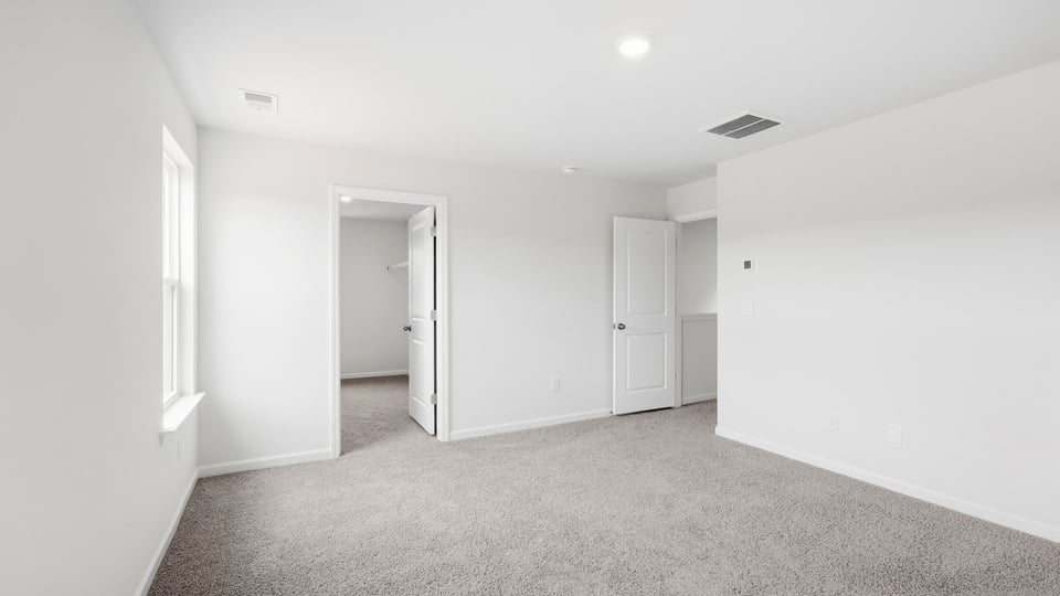 Bedroom with carpet and window.