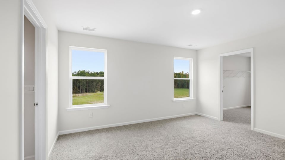 Bedroom with carpet and window.