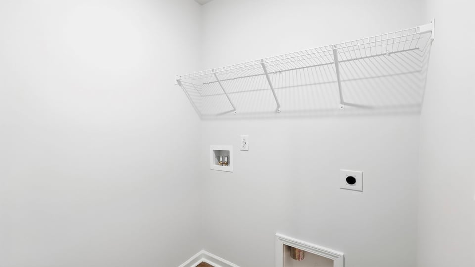 Laundry room with hanging storage racks.