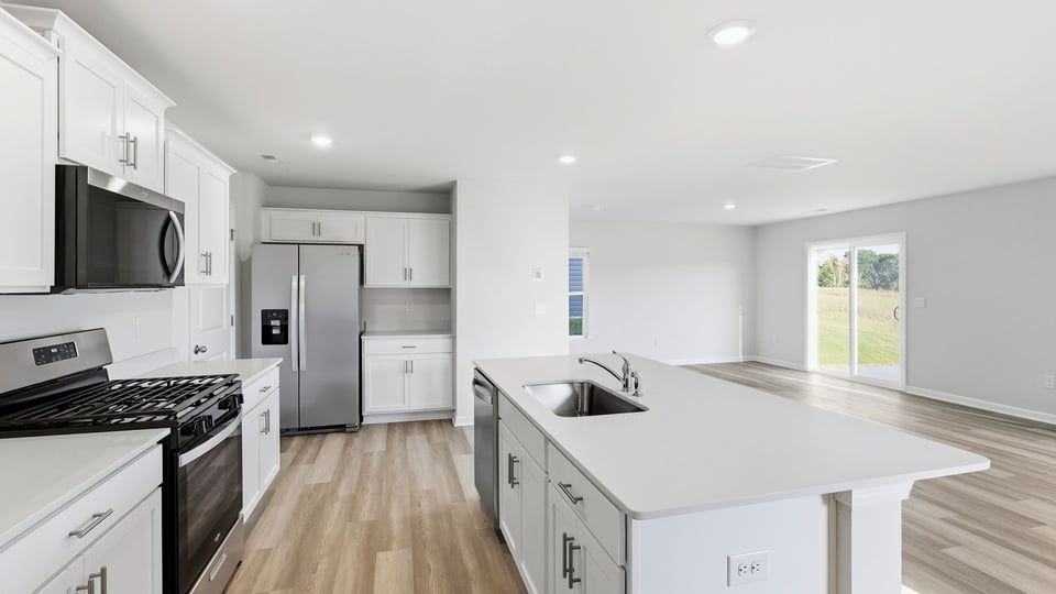 Kitchen and island with quartz countertops.