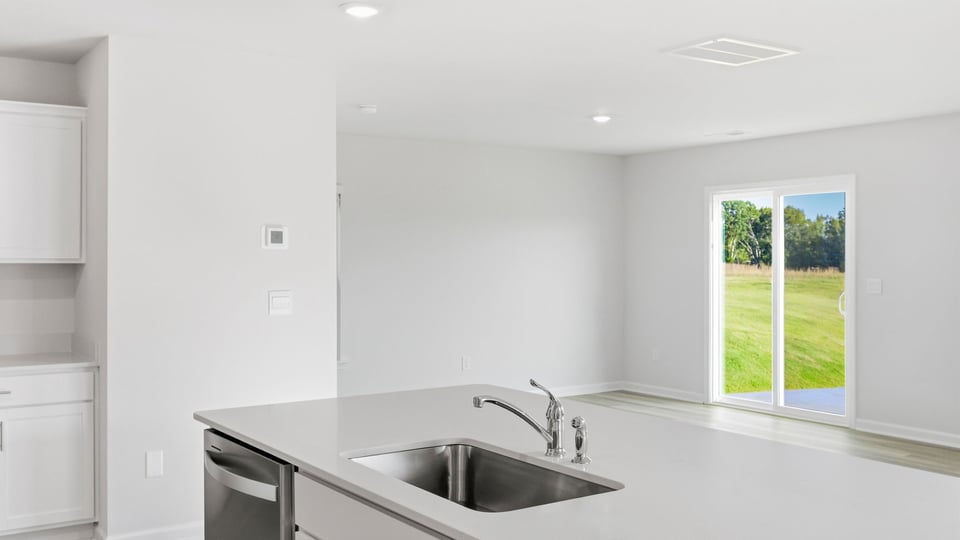 Kitchen and island with quartz countertops.