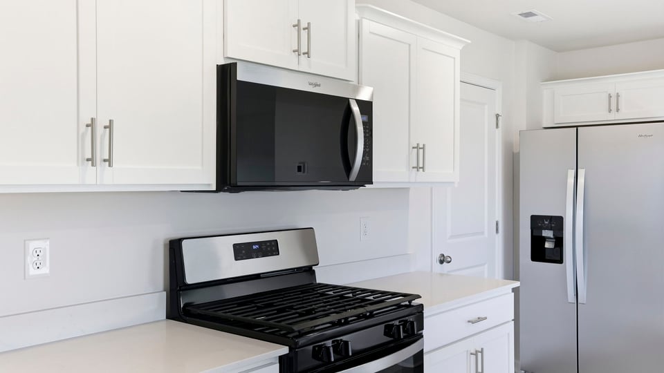 Kitchen and island with quartz countertops.