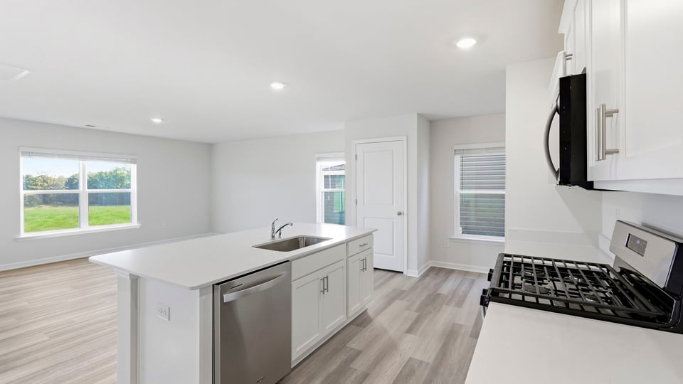 Kitchen and island with quartz countertops.