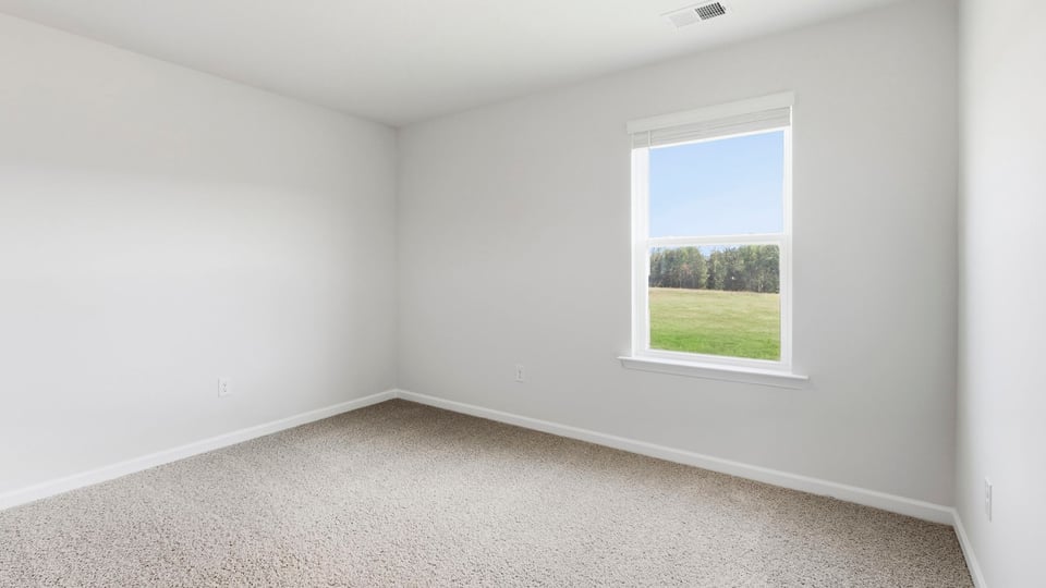 Bedroom with carpet and window.