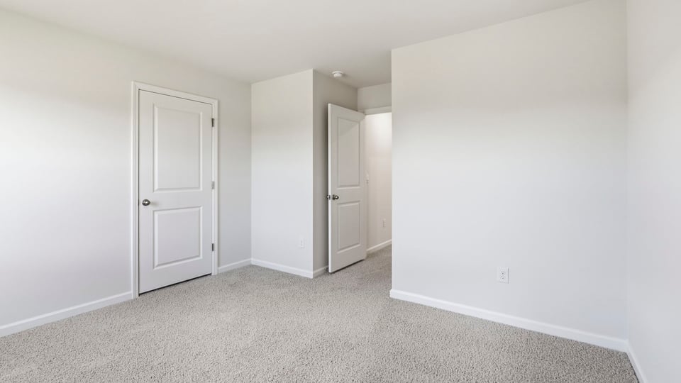 Bedroom with carpet and window.