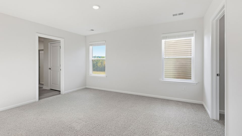 Bedroom with carpet and window.